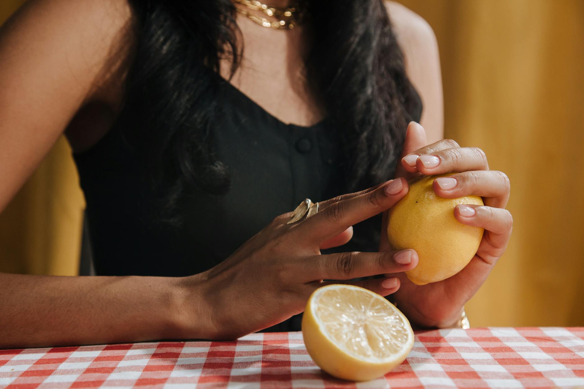 A hand holding a silicone clitoral vibrator, representing reclaiming pleasure during stressful periods