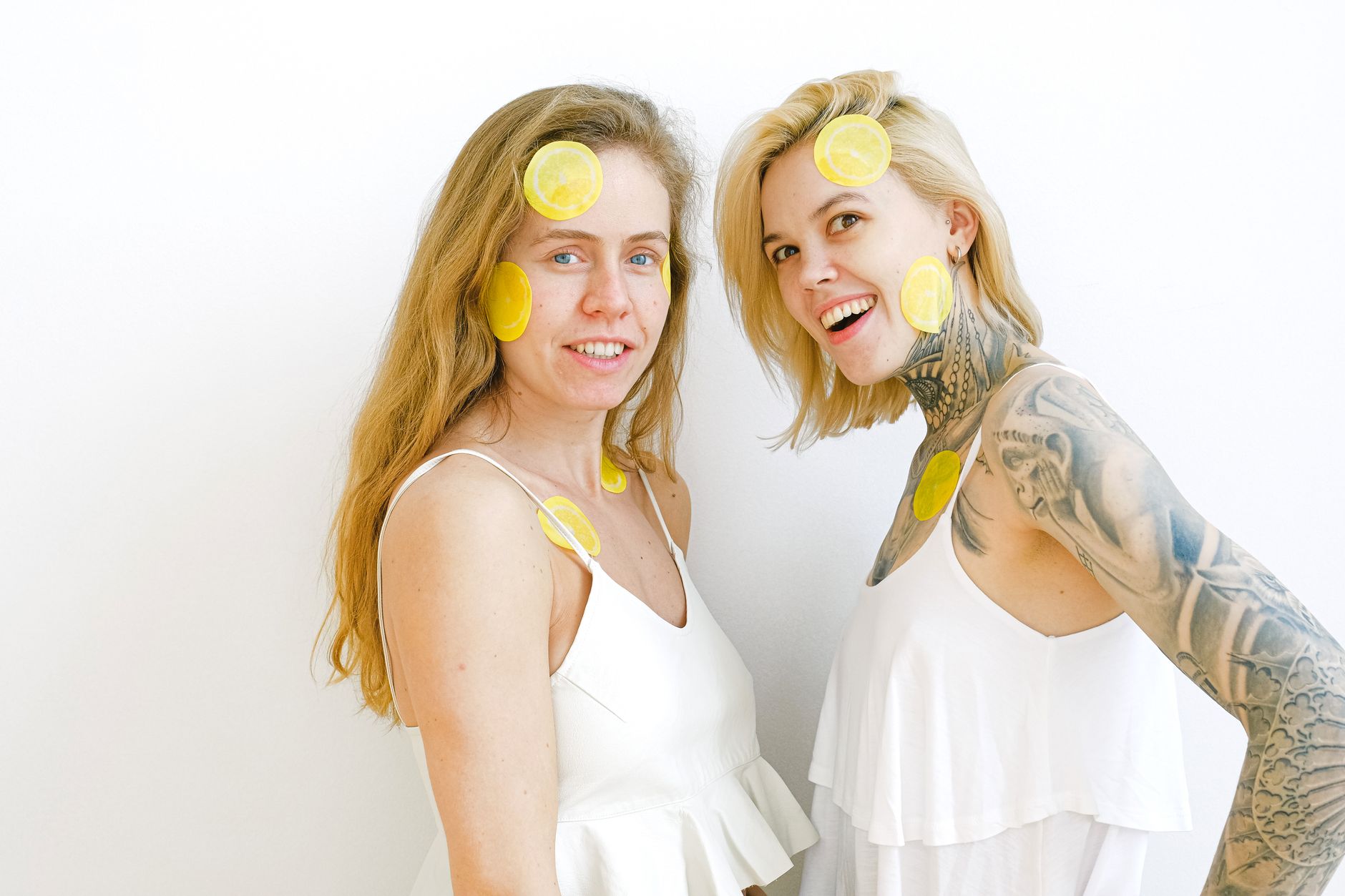 Yellow silicone vibrator with fresh lemons on bright yellow background
