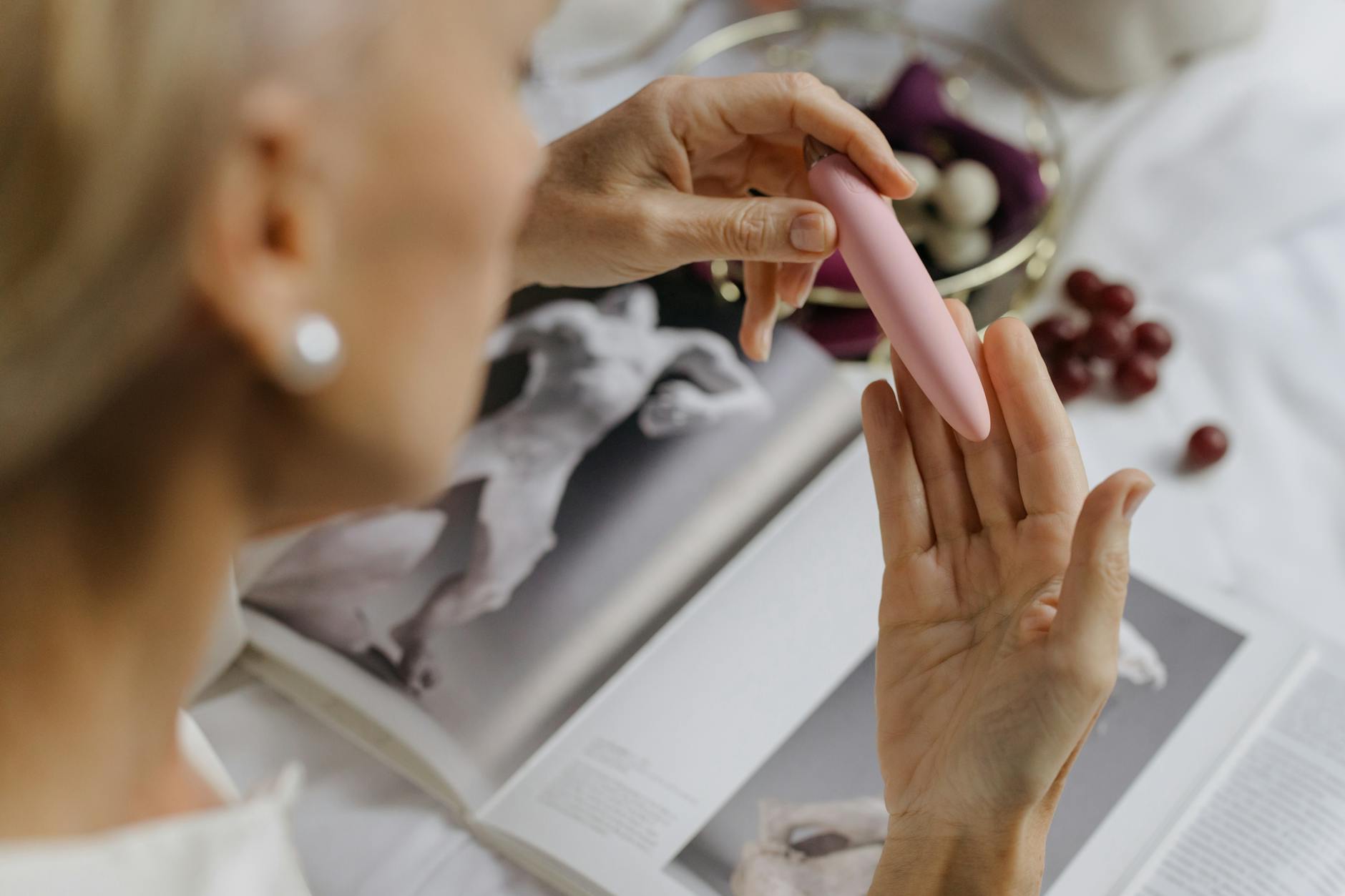 Hands holding pastel-colored silicone toys, illustrating intimate connection and shared pleasure