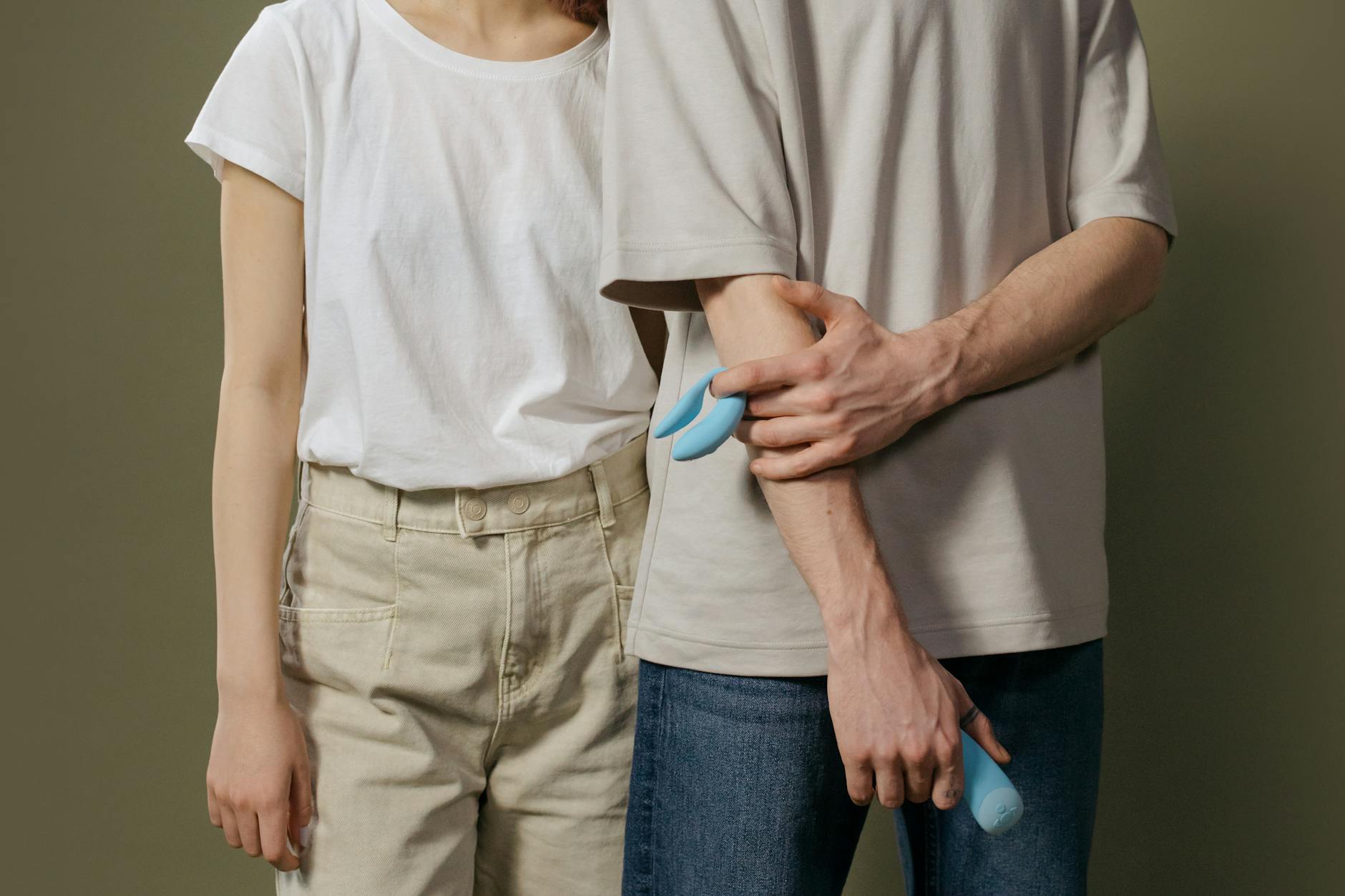 A couple standing together indoors, exploring intimacy with a modern vibrator to restore connection.