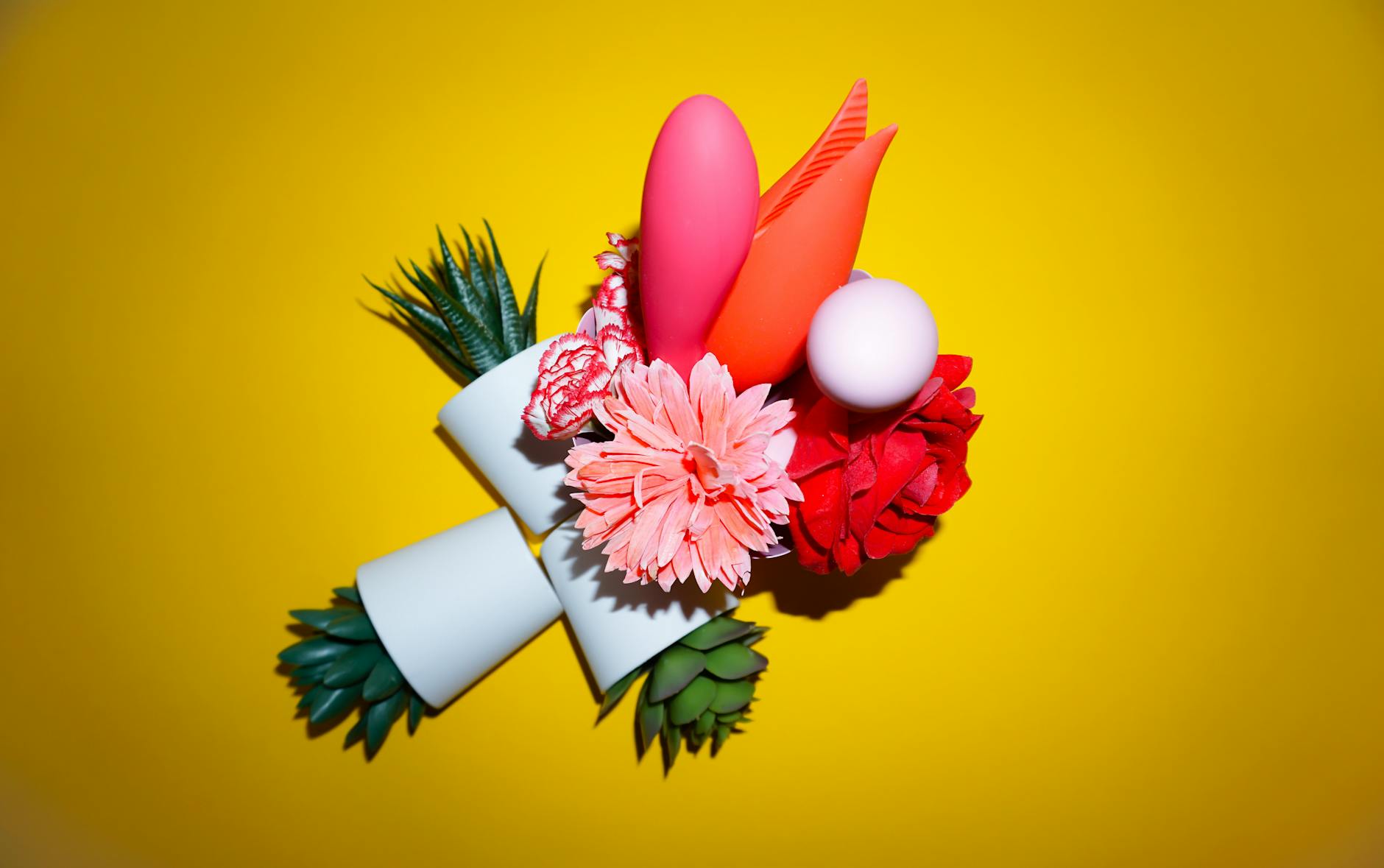 Three colorful vibrators on white fabric showing smooth texture